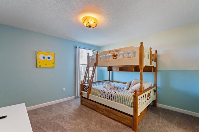 carpeted bedroom featuring a textured ceiling and baseboards