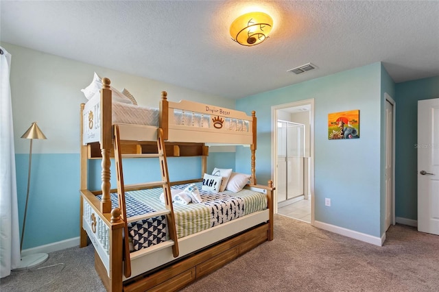 bedroom featuring a textured ceiling, carpet floors, visible vents, and baseboards