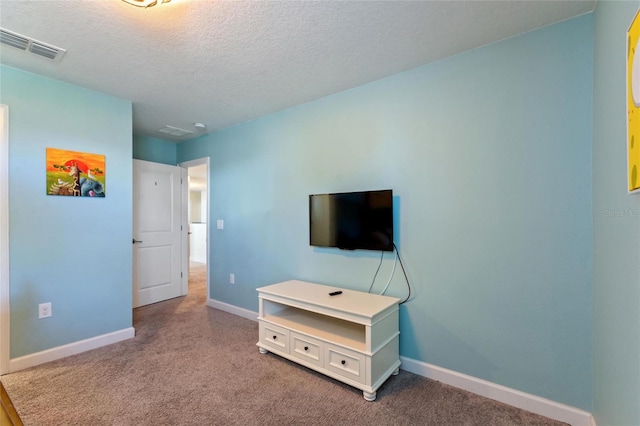 carpeted bedroom with a textured ceiling, visible vents, and baseboards