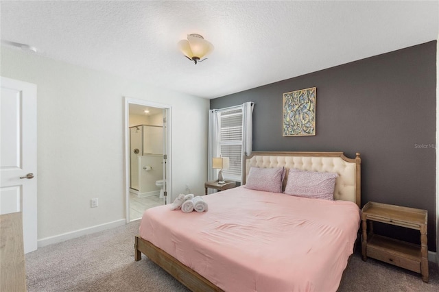 bedroom featuring carpet flooring, connected bathroom, a textured ceiling, and baseboards