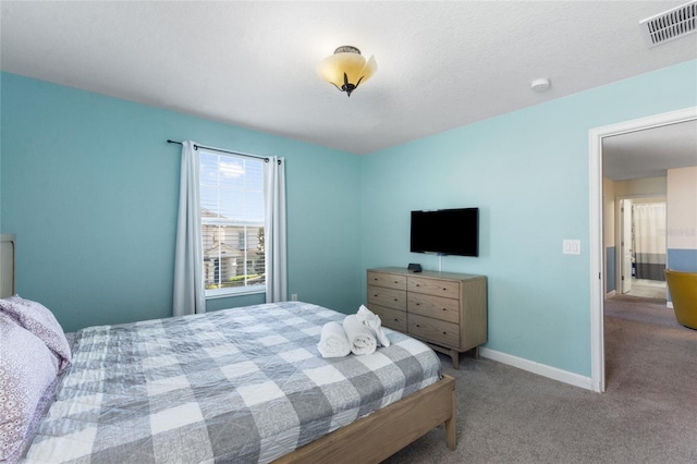 carpeted bedroom with visible vents and baseboards