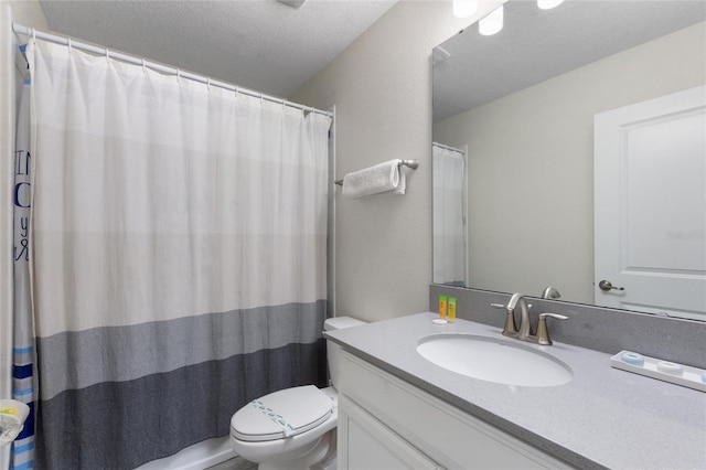 full bath featuring curtained shower, toilet, vanity, and a textured ceiling