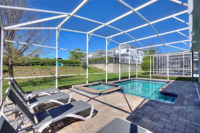 view of swimming pool featuring glass enclosure, a patio area, and a lawn