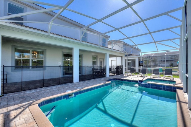 view of pool with a patio, a lanai, and a pool with connected hot tub