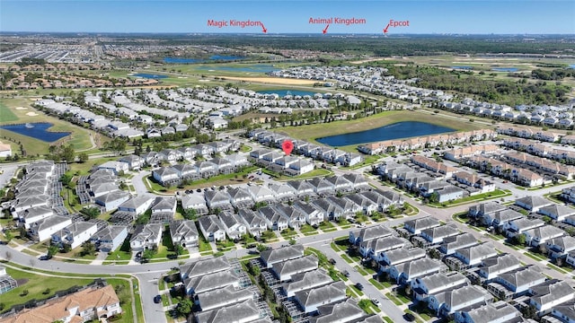 birds eye view of property with a water view and a residential view