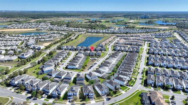 drone / aerial view with a water view and a residential view