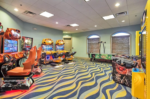 game room with carpet, visible vents, and a drop ceiling