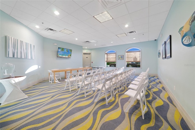 rec room with carpet floors, visible vents, and baseboards