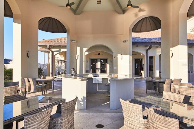 view of patio with ceiling fan, french doors, and outdoor wet bar