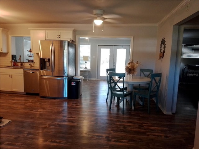 kitchen featuring appliances with stainless steel finishes, french doors, a sink, and dark wood-style flooring