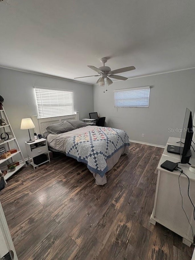 bedroom featuring baseboards, multiple windows, a ceiling fan, and dark wood-style flooring