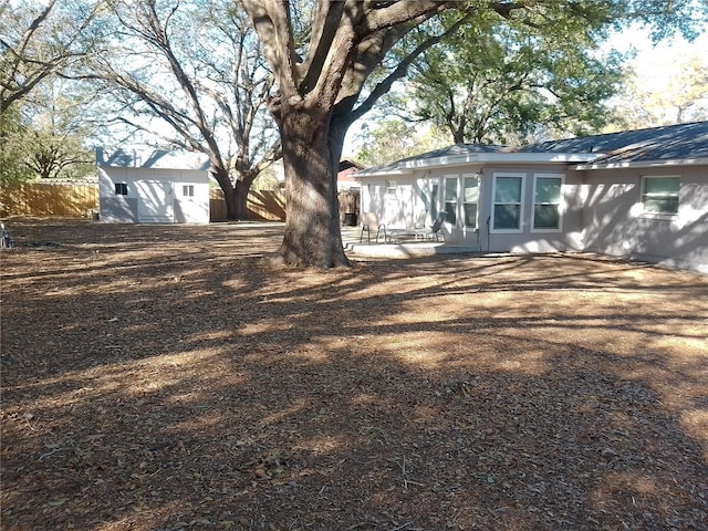 exterior space featuring an outdoor structure and fence