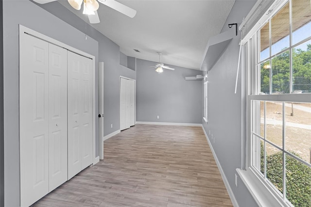 16017 Harbar Oaks Dr, Montverde, FL 34756 - corridor featuring vaulted ceiling, light wood-style flooring, and baseboards