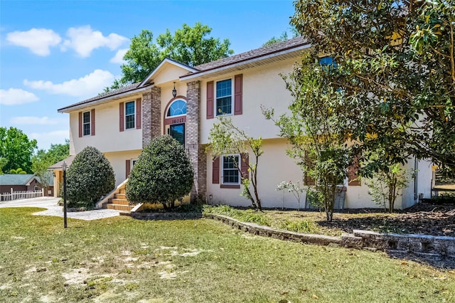 16017 Harbar Oaks Dr, Montverde, FL 34756 - raised ranch featuring a front lawn, brick siding, stucco siding, and driveway