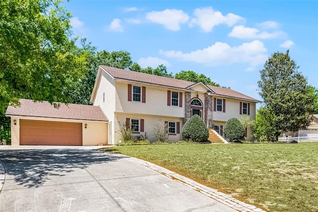 16017 Harbar Oaks Dr, Montverde, FL 34756 - bi-level home with stucco siding, driveway, an attached garage, and a front yard