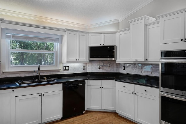 16017 Harbar Oaks Dr, Montverde, FL 34756 - kitchen with stainless steel appliances, a sink, dark countertops, tasteful backsplash, and a textured ceiling