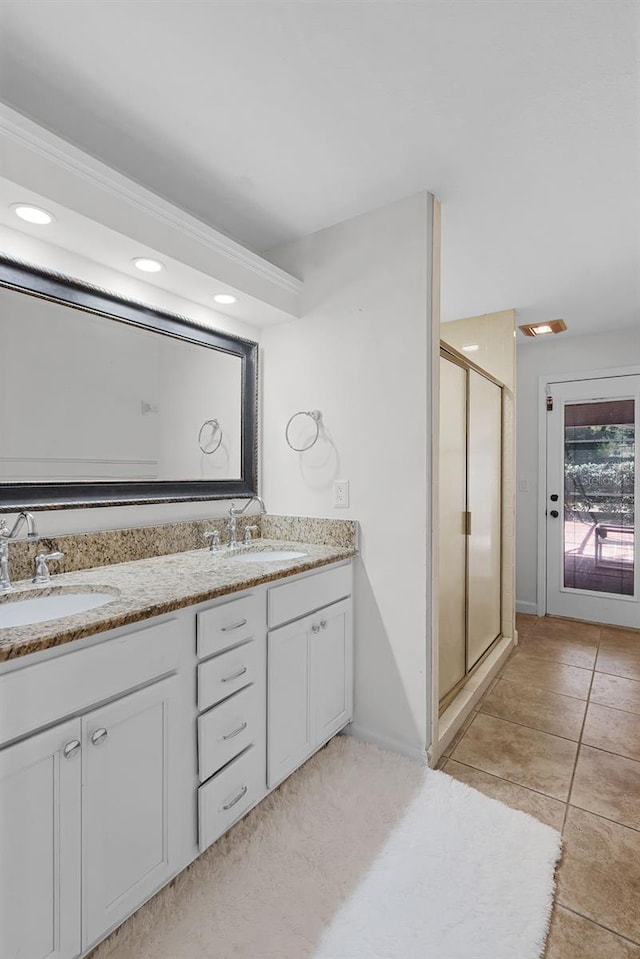16017 Harbar Oaks Dr, Montverde, FL 34756 - full bath with a stall shower, double vanity, tile patterned floors, recessed lighting, and baseboards