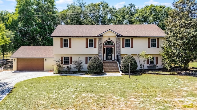 16017 Harbar Oaks Dr, Montverde, FL 34756 - bi-level home featuring stucco siding, driveway, an attached garage, and a front lawn
