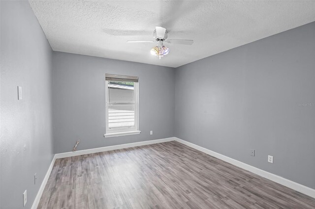 16017 Harbar Oaks Dr, Montverde, FL 34756 - empty room with wood finished floors, a ceiling fan, baseboards, and a textured ceiling