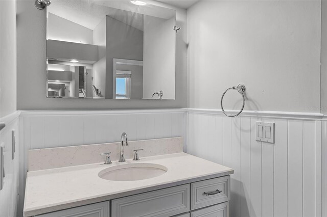 16017 Harbar Oaks Dr, Montverde, FL 34756 - bathroom with a wainscoted wall and vanity