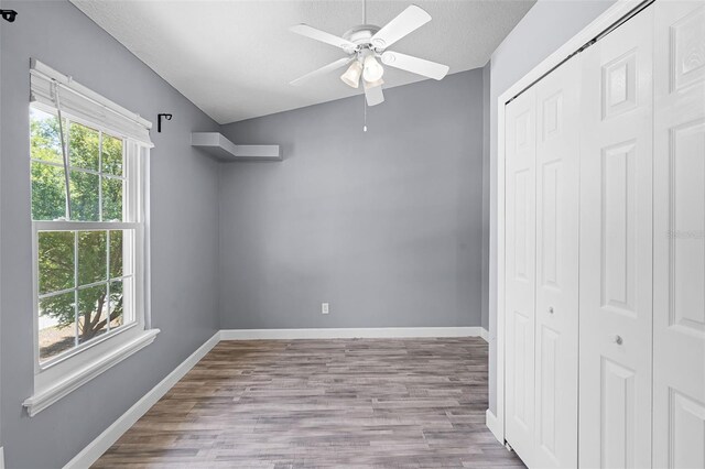16017 Harbar Oaks Dr, Montverde, FL 34756 - unfurnished bedroom featuring a closet, wood finished floors, baseboards, ceiling fan, and a textured ceiling