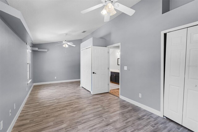 16017 Harbar Oaks Dr, Montverde, FL 34756 - unfurnished bedroom featuring wood finished floors, baseboards, ceiling fan, and multiple closets