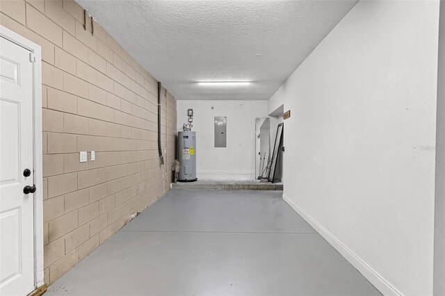 16017 Harbar Oaks Dr, Montverde, FL 34756 - hall featuring a textured ceiling, electric water heater, finished concrete flooring, and electric panel