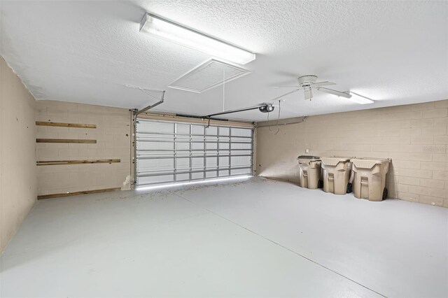 16017 Harbar Oaks Dr, Montverde, FL 34756 - garage with a garage door opener, a ceiling fan, and concrete block wall