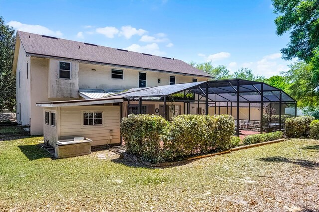 16017 Harbar Oaks Dr, Montverde, FL 34756 - rear view of house with a lawn, a shingled roof, a lanai, and metal roof