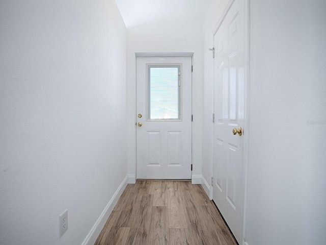 entryway with light wood-type flooring and baseboards