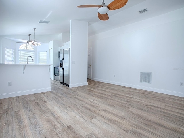 unfurnished living room featuring light wood-type flooring, visible vents, and baseboards