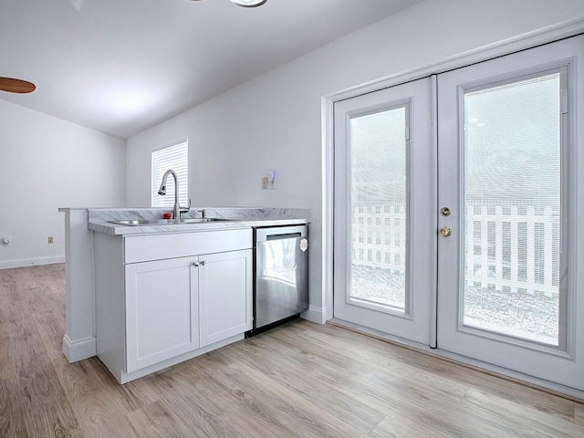 kitchen featuring a sink, plenty of natural light, french doors, and stainless steel dishwasher