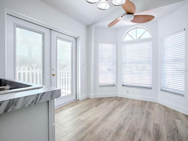 unfurnished dining area featuring plenty of natural light, light wood-style floors, and baseboards