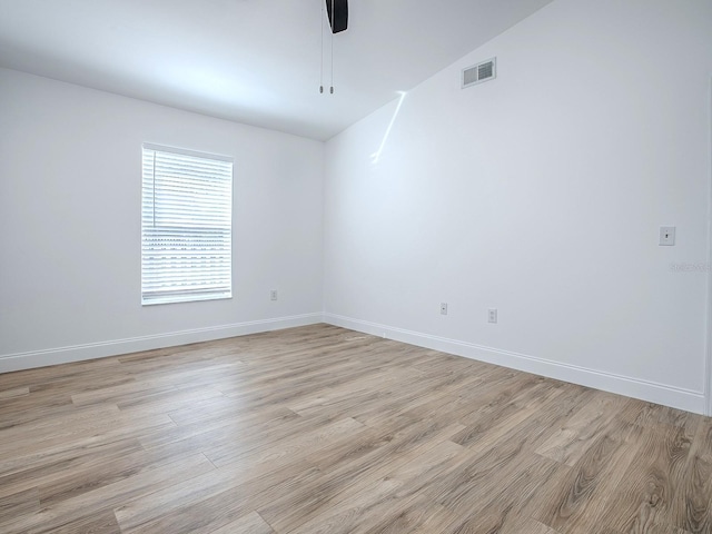 empty room with light wood-type flooring, visible vents, baseboards, and ceiling fan