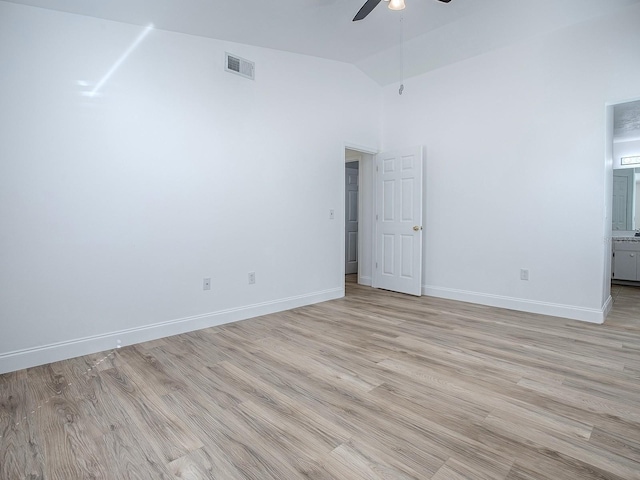 empty room with a ceiling fan, visible vents, baseboards, high vaulted ceiling, and light wood-style floors