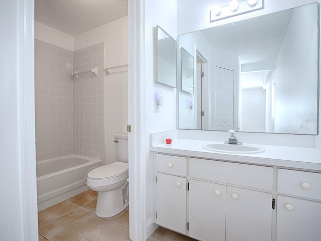 full bath featuring tile patterned floors, toilet, vanity, and washtub / shower combination