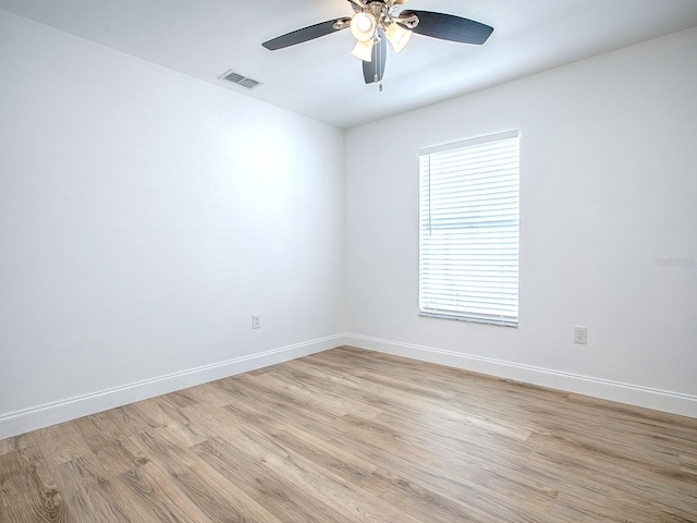 unfurnished room featuring visible vents, baseboards, and light wood-style floors