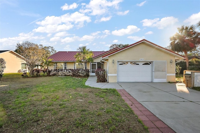 ranch-style house with metal roof, a garage, driveway, stucco siding, and a front lawn