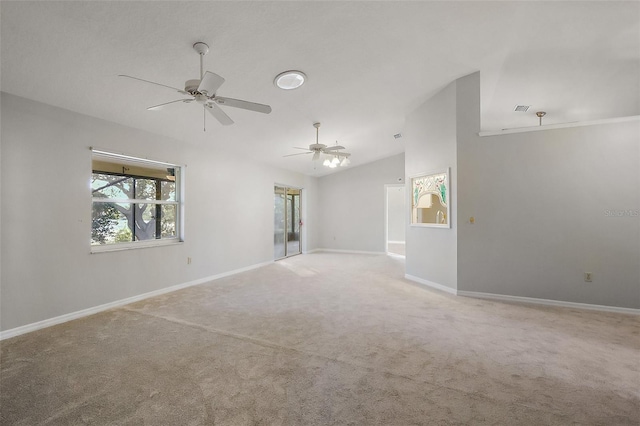 unfurnished room featuring carpet floors, baseboards, vaulted ceiling, and a ceiling fan