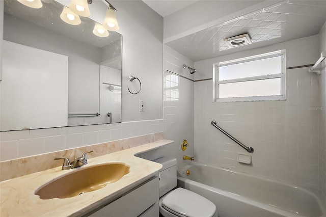 full bathroom featuring tasteful backsplash, toilet, vanity, shower / bathtub combination, and tile walls