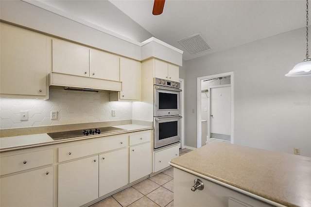 kitchen with black electric stovetop, visible vents, double oven, light tile patterned flooring, and under cabinet range hood