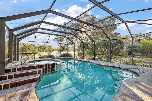 view of swimming pool featuring a patio, glass enclosure, and a pool with connected hot tub