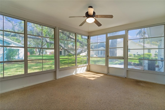 unfurnished sunroom featuring plenty of natural light and ceiling fan