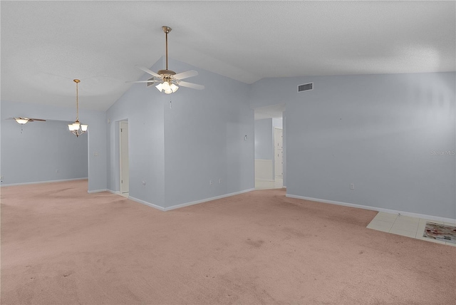 empty room featuring baseboards, visible vents, a textured ceiling, light carpet, and ceiling fan with notable chandelier