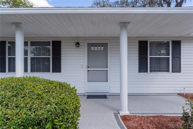 view of exterior entry with covered porch