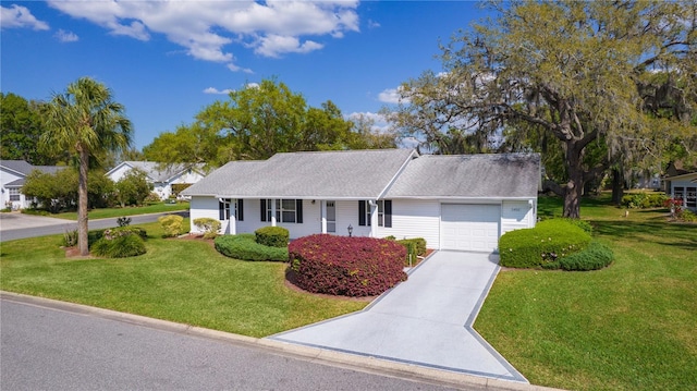 single story home featuring a front yard, a garage, and driveway