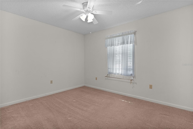 unfurnished room with baseboards, a textured ceiling, carpet, and a ceiling fan