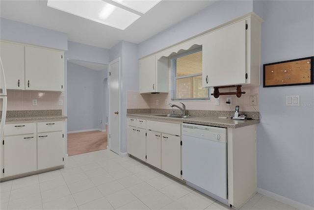 kitchen featuring a sink, decorative backsplash, and white dishwasher