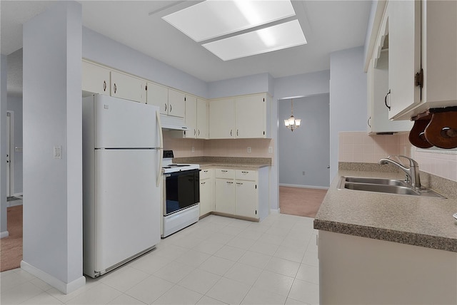 kitchen with a sink, under cabinet range hood, tasteful backsplash, white appliances, and baseboards