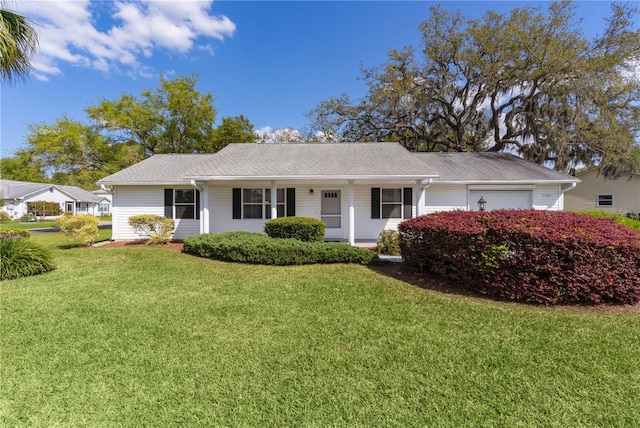 ranch-style home with roof with shingles and a front lawn